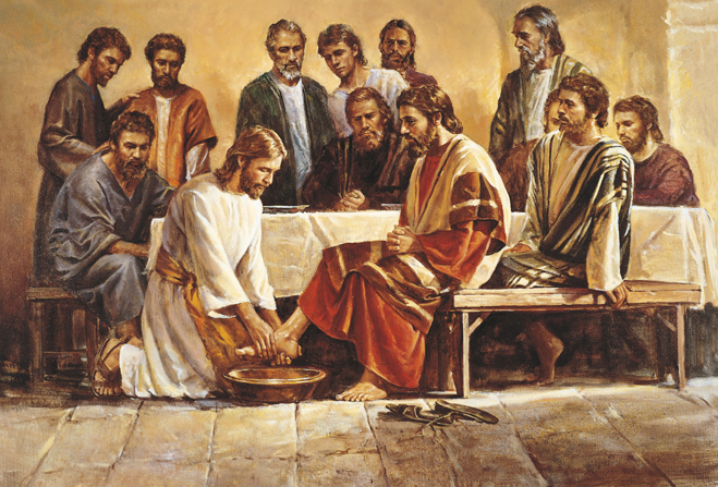 Christ in white robes with a yellow sash, kneeling to wash the feet of one of His Apostles while the other eleven sit around the table.