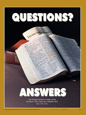 A poster depicting a set of scriptures lying open next to a newspaper with current events, paired with the words “Questions? Answers.”