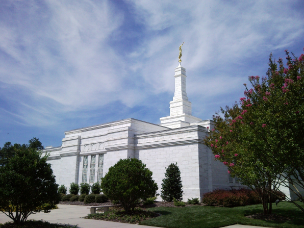 A side view of the Raleigh North Carolina Temple, including a view of the spire and the trees on the temple grounds.