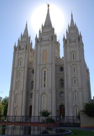 The front of the Salt Lake Temple, with a partial view of the reflecting pond in front.