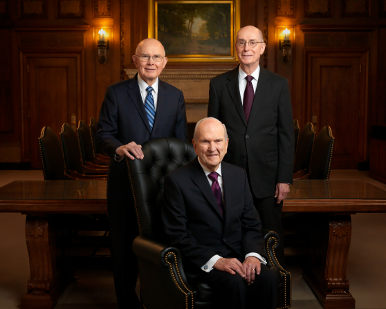 A portrait of the First Presidency, with President Russell M. Nelson seated in a chair and President Dallin H. Oaks and President Henry B. Eyring standing behind him.