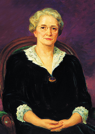 A painted portrait by Lee Greene Richards of Amy Brown Lyman against a purple background, sitting in a wooden chair with green upholstery. She is wearing a black dress trimmed in white lace.
