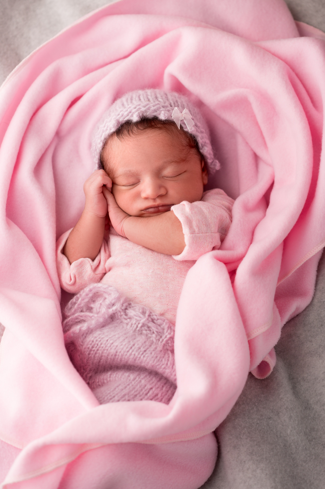 newborn in a pink blanket pink baby girls