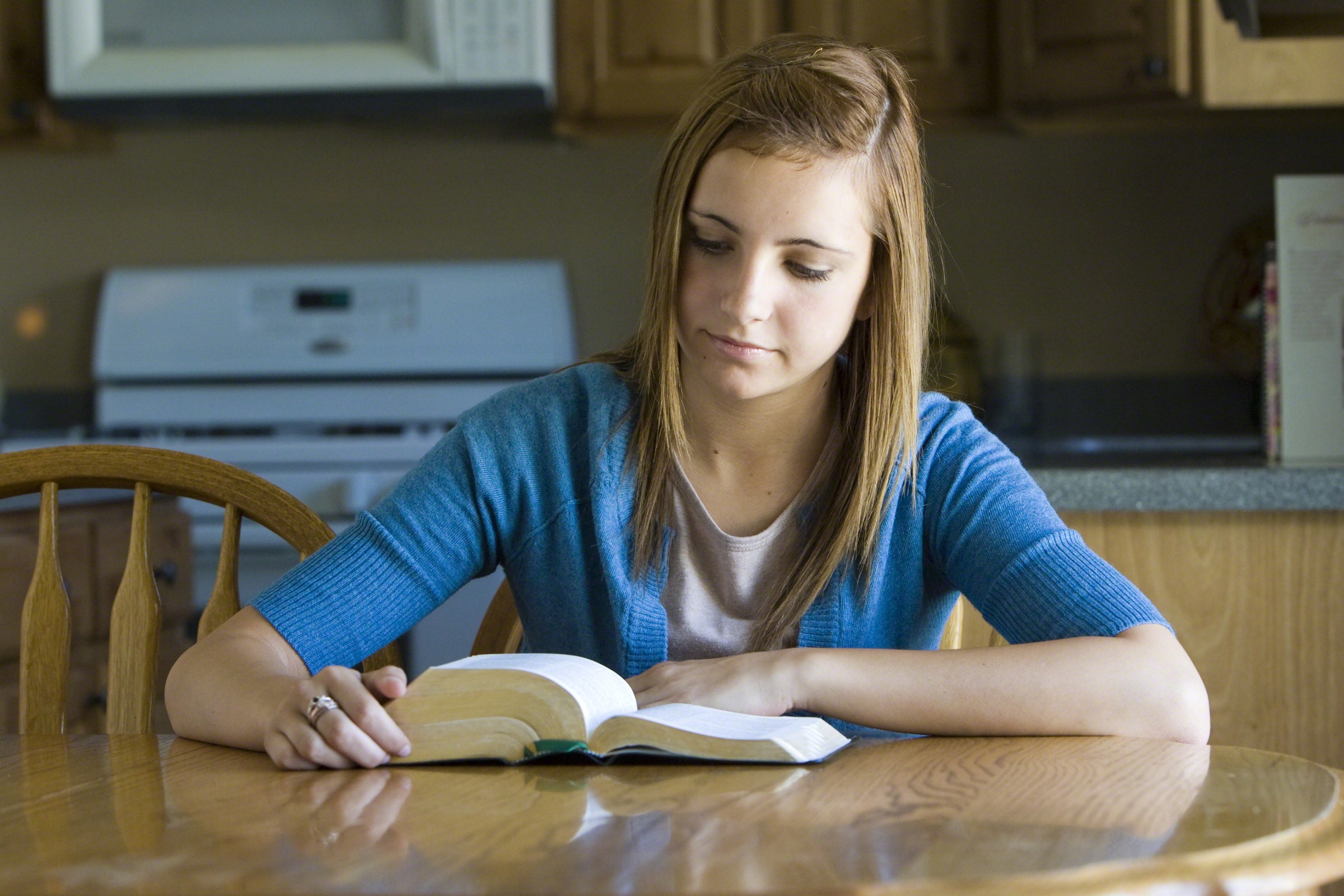 Girl reading the scriptures, studying the tongue of angels