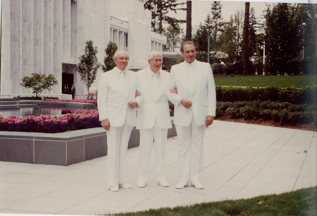 President Benson standing with his two counselors, President Monson and President Hinckley, all three in white clothes at the Portland Oregon Temple dedication.