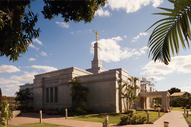 The Asunción Paraguay Temple in the daytime, with trees in the foreground and the words “Holiness to the Lord: The House of the Lord” above the door.