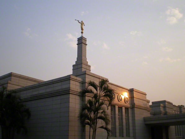 A view of the spire and angel Moroni statue on top of the Asunción Paraguay Temple during sunset.